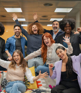 A group of happy employees and their employer during a celebration as they make New Year’s resolutions for work to ensure 2026 starts off on the right foot.